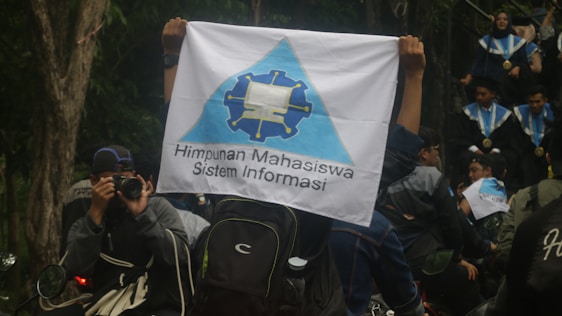 A bright and lively group photo of OSIS members at SMP IT Qur'any, smiling and engaging in a school event.