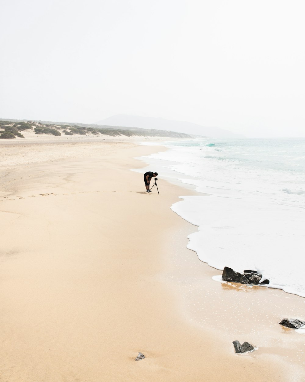 person walking on beach during daytime