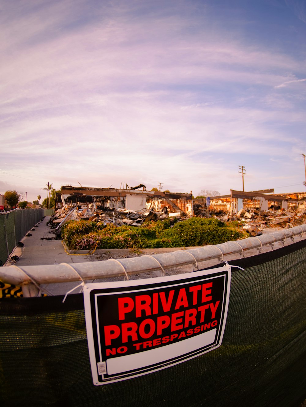 a private property sign is posted on a fence