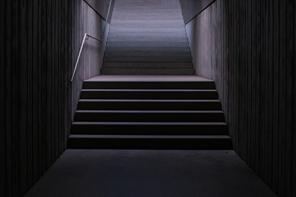 gray concrete staircase with stainless steel railings