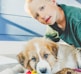 a young boy playing with a dog on the floor