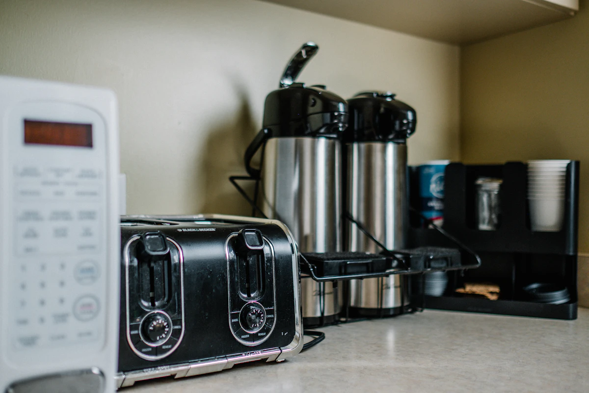 Stainless steel bread toaster on a wooden counter