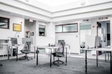black metal chairs and table near white wall