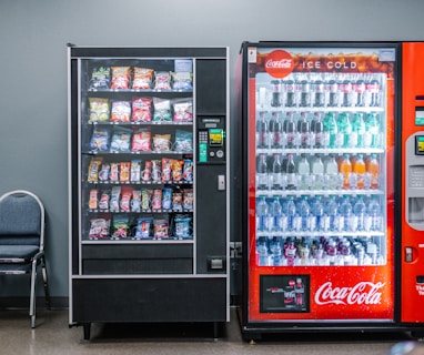 coca cola and coca cola bottles in black vending machine