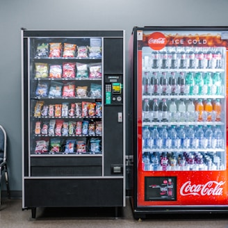 coca cola and coca cola bottles in black vending machine