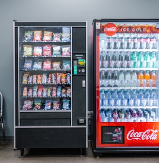 coca cola and coca cola bottles in black vending machine