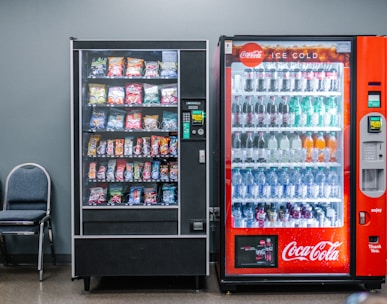 coca cola and coca cola bottles in black vending machine