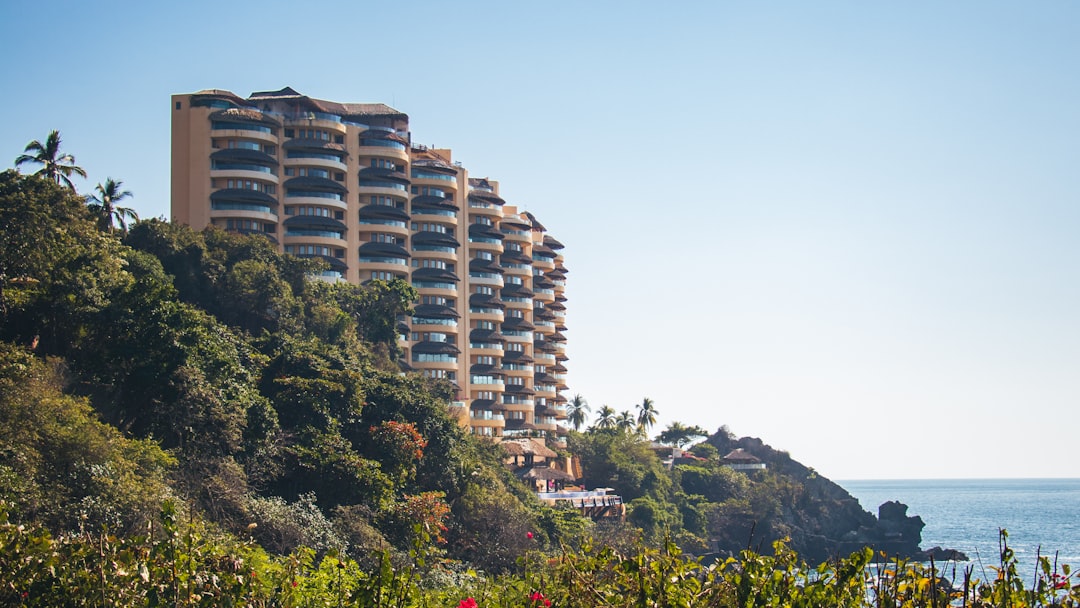 brown concrete building on mountain