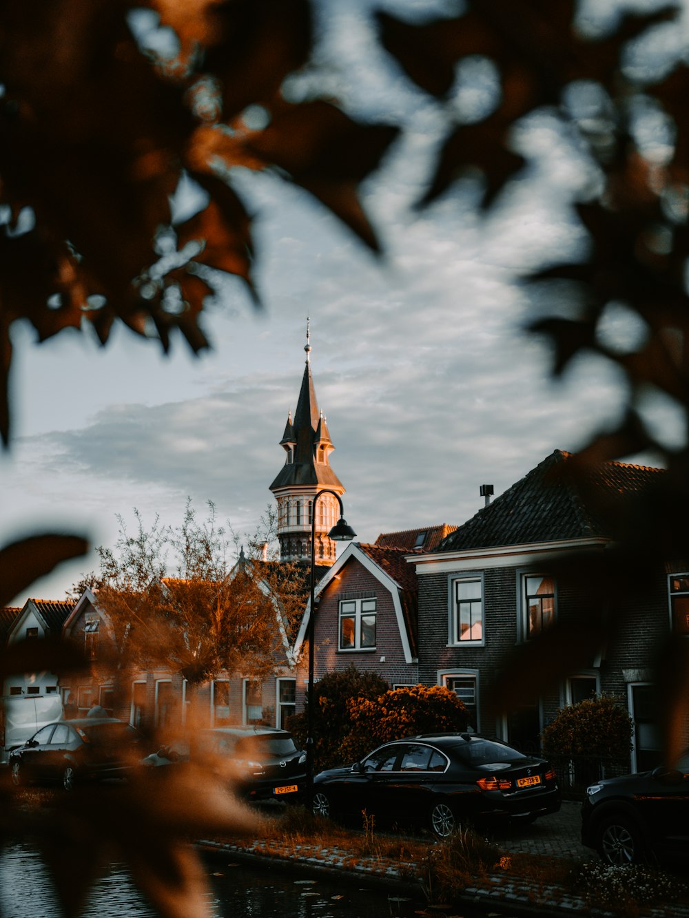 cars parked beside brown and white concrete building during sunset