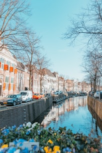 river between concrete buildings during daytime