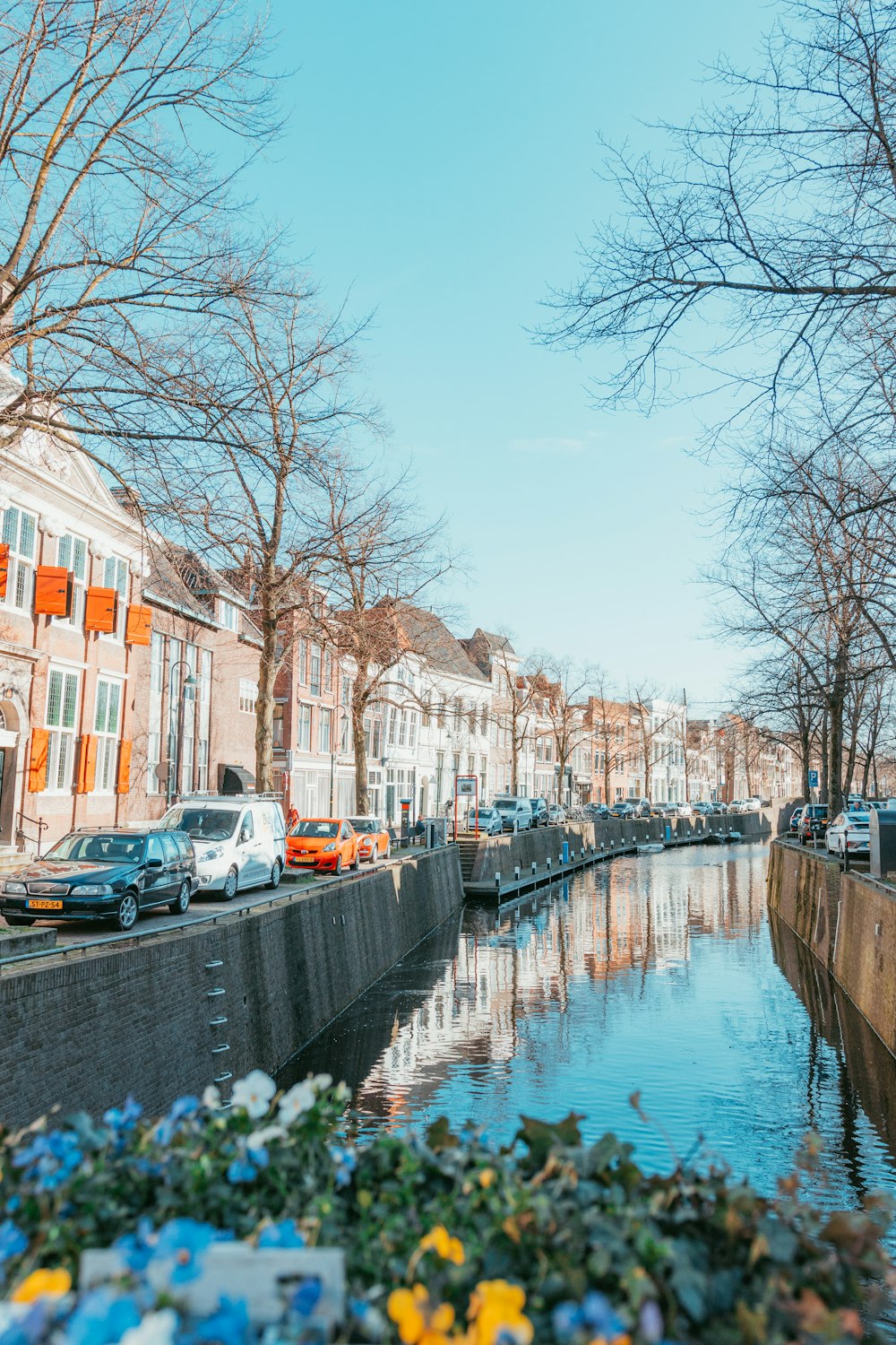 river between concrete buildings during daytime