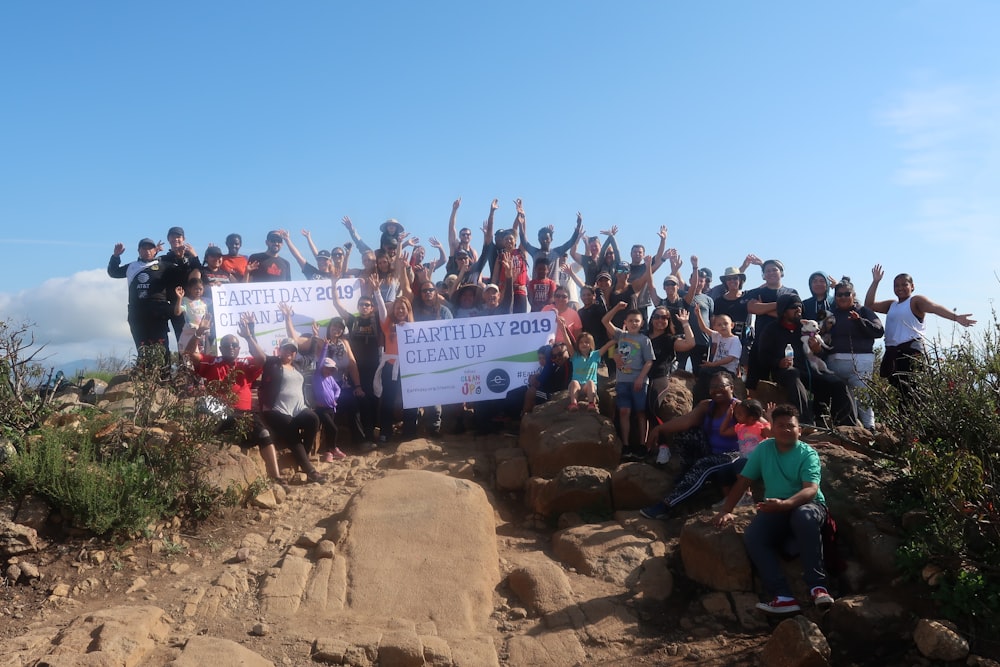 people on brown rocky mountain during daytime