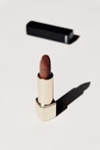 Elegant lipstick shades in gold-accented tubes on a black velvet cloth