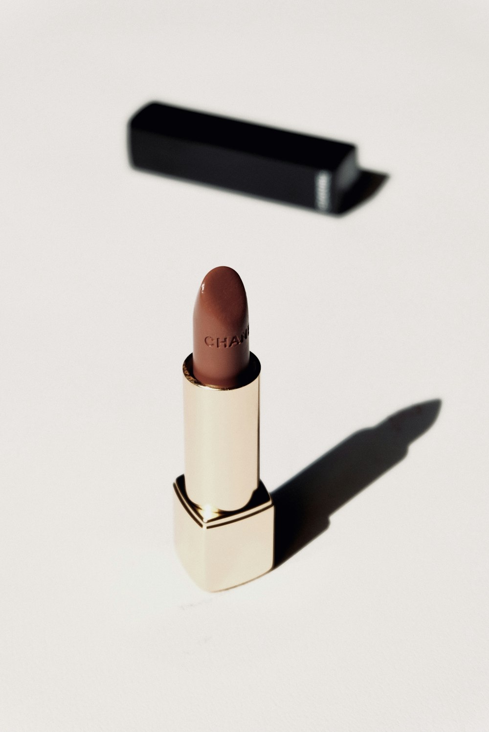 brown lipstick on white surface