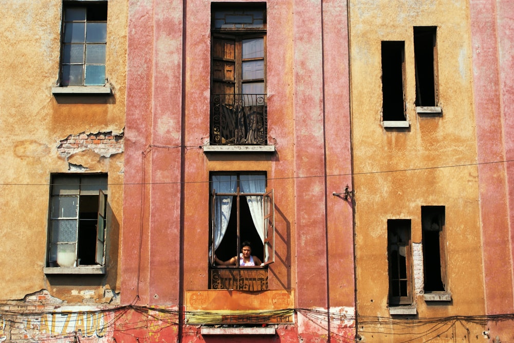 brown concrete building with white wooden window