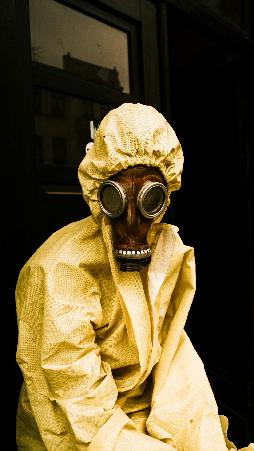 person wearing yellow gas mask and white robe