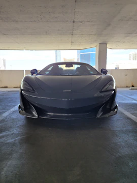 A sleek luxury car parked in a modern cityscape.