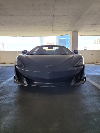 A sleek luxury car parked in a modern garage.