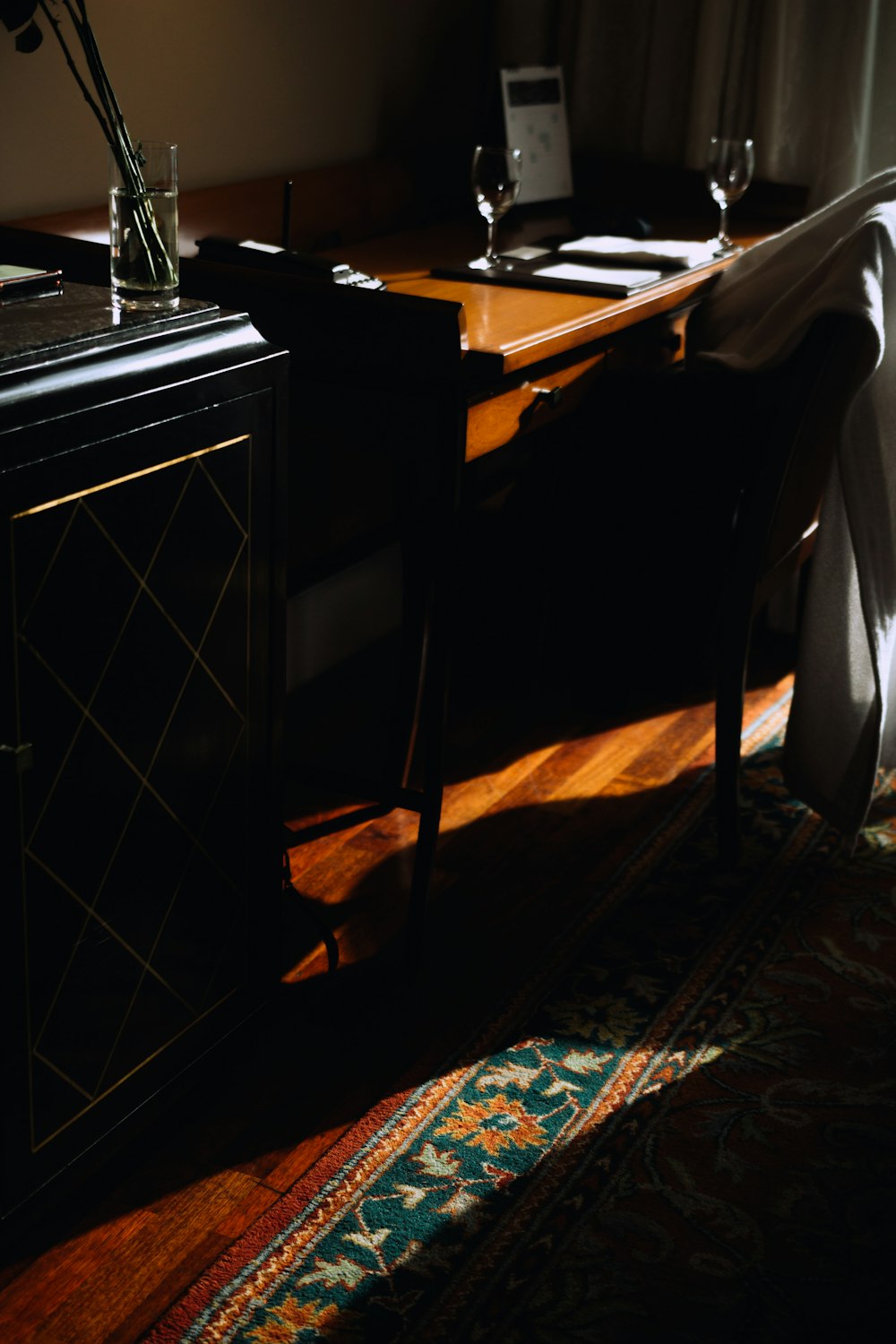 brown wooden table on black and white checkered floor