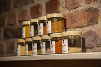 clear glass jars on brown wooden shelf