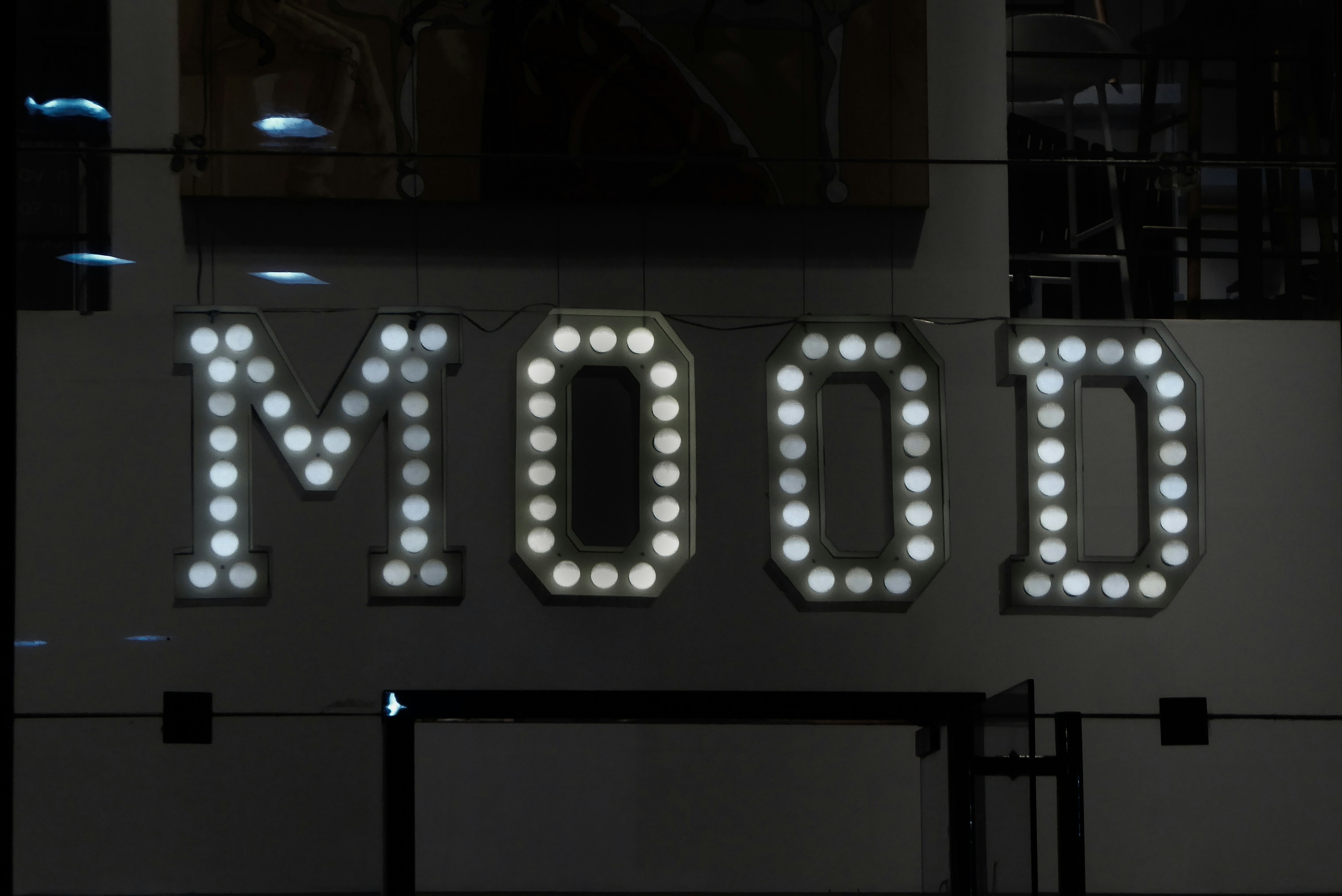 The word mood, illuminated by white lightbulbs.