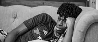 A thoughtful person lying on a couch during a psychoanalysis session.