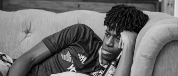 A thoughtful person lying on a couch during a psychoanalysis session.