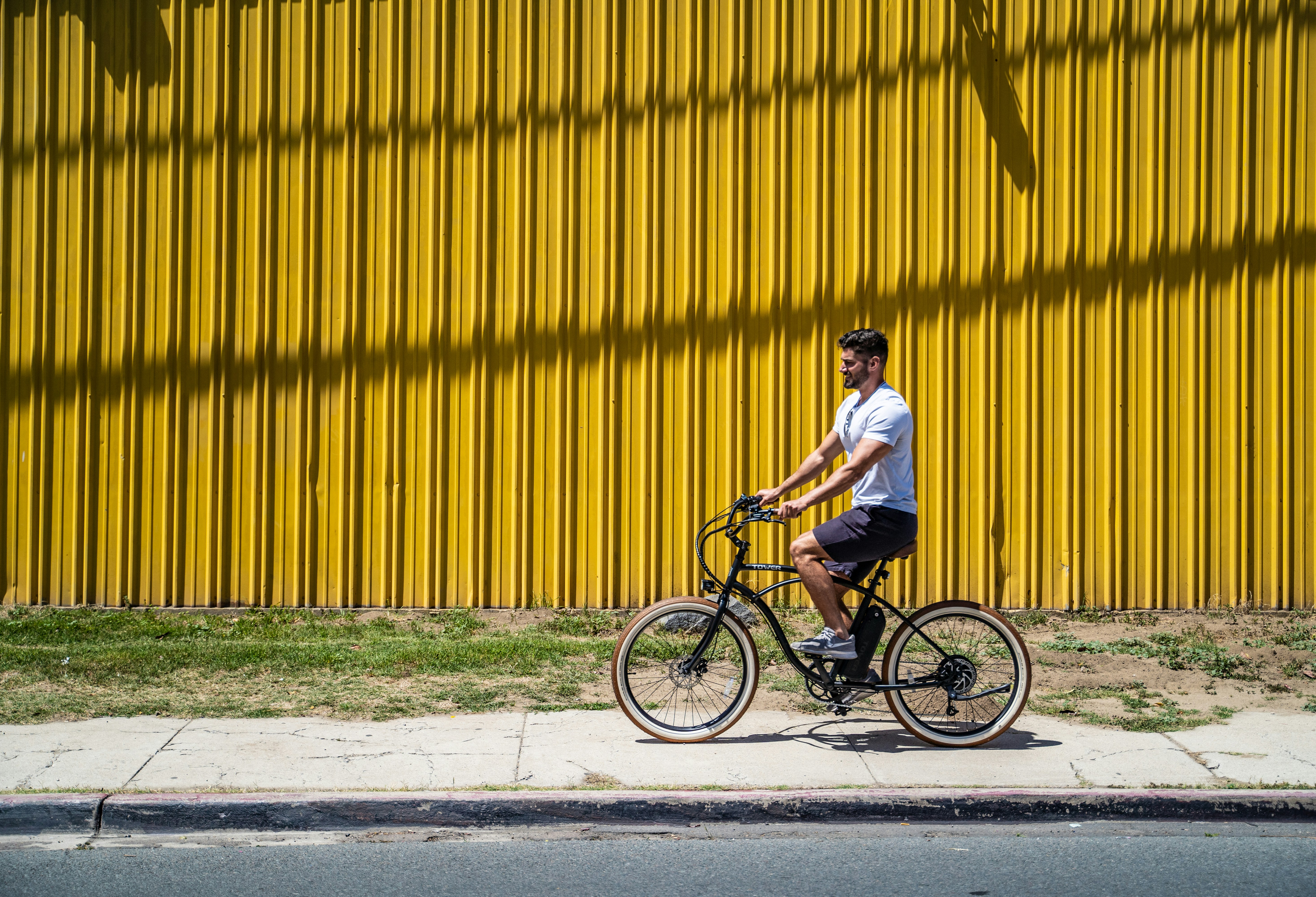 man in white shirt riding on black bicycle during daytime