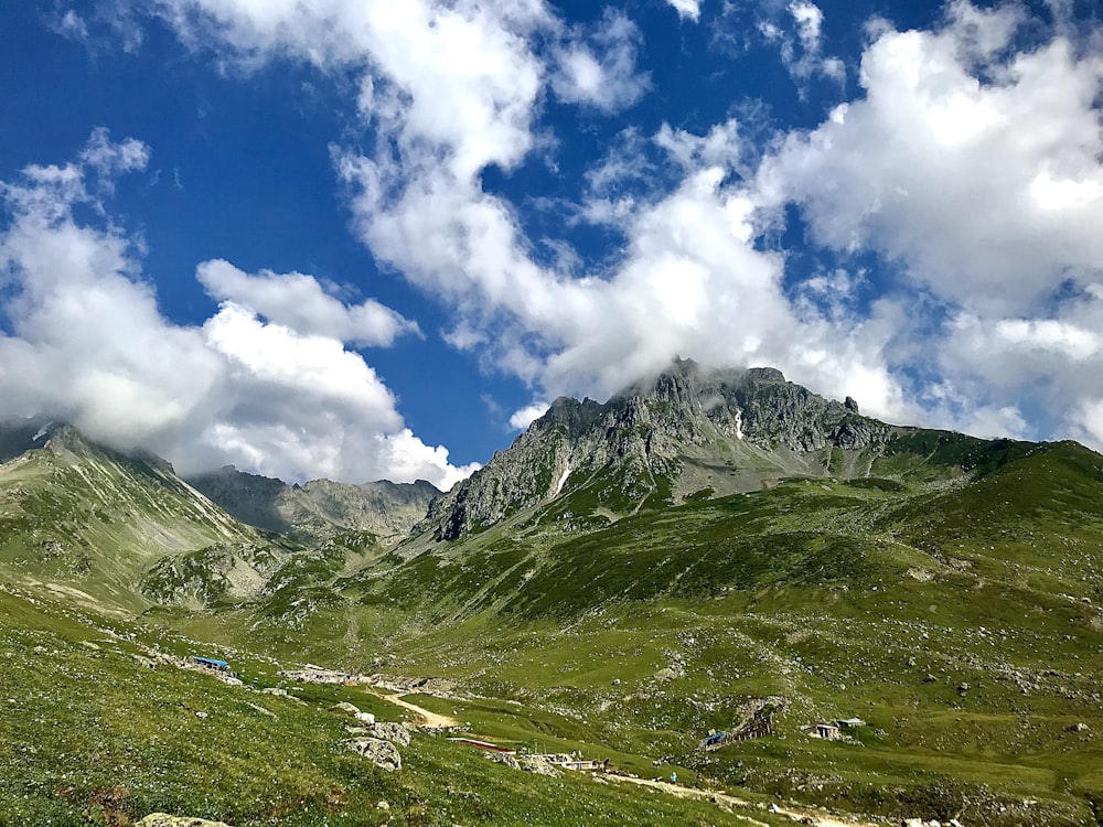 green and brown mountain under blue sky and white clouds during daytime