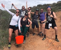 group of people standing on brown soil during daytime