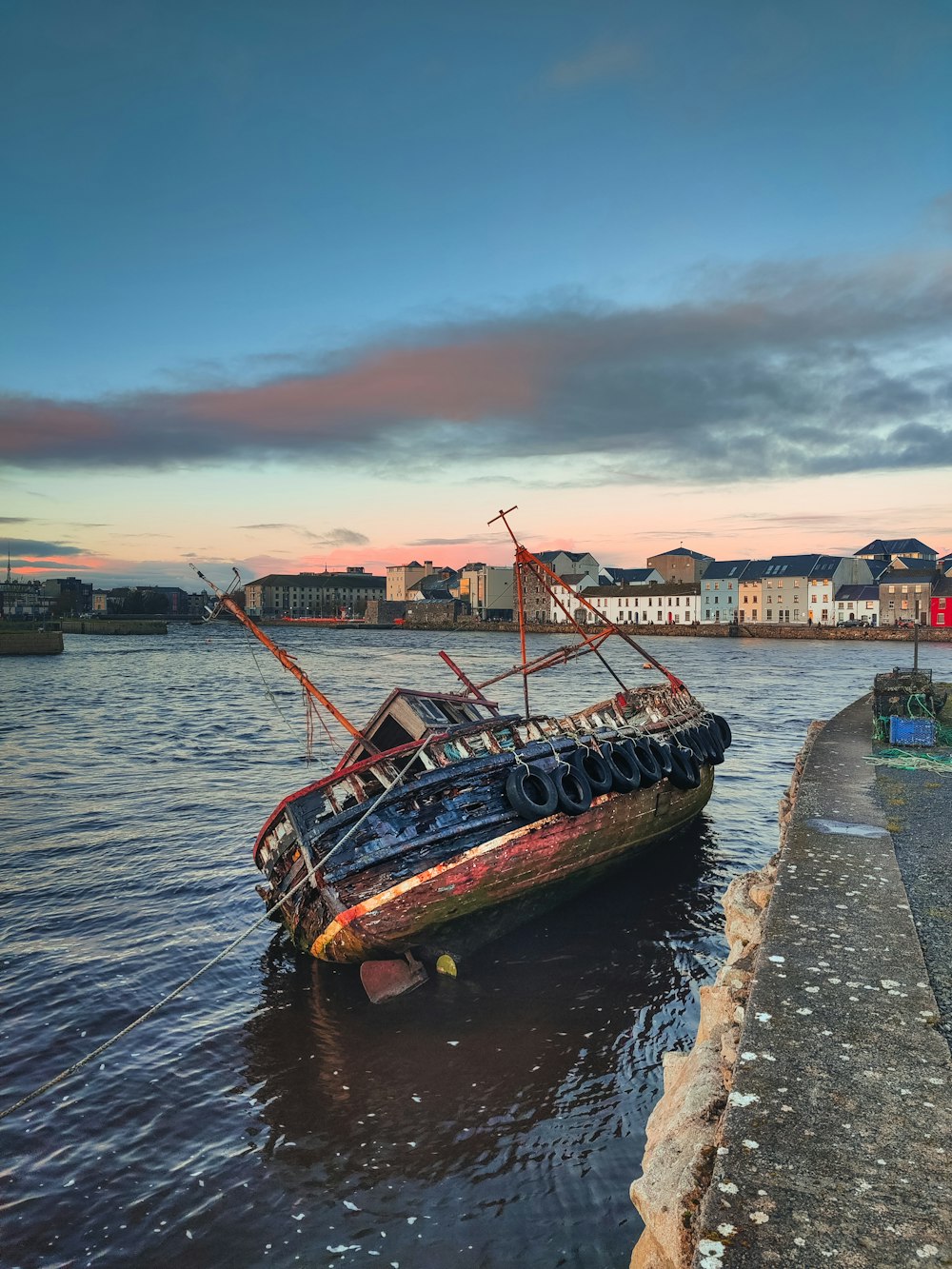 brown boat on dock during sunset