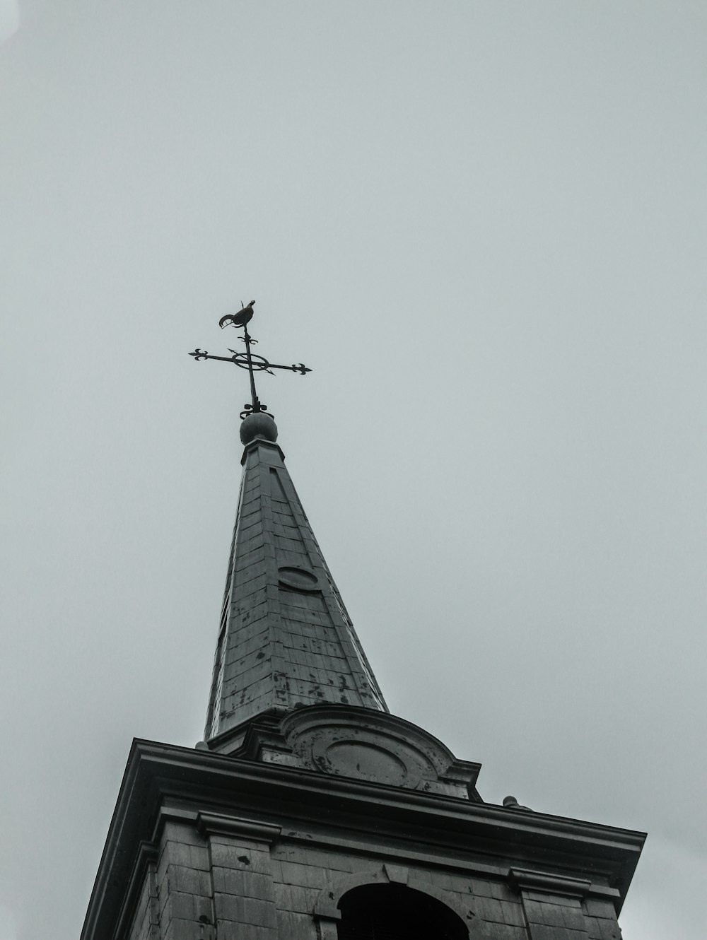 black cross on top of black tower