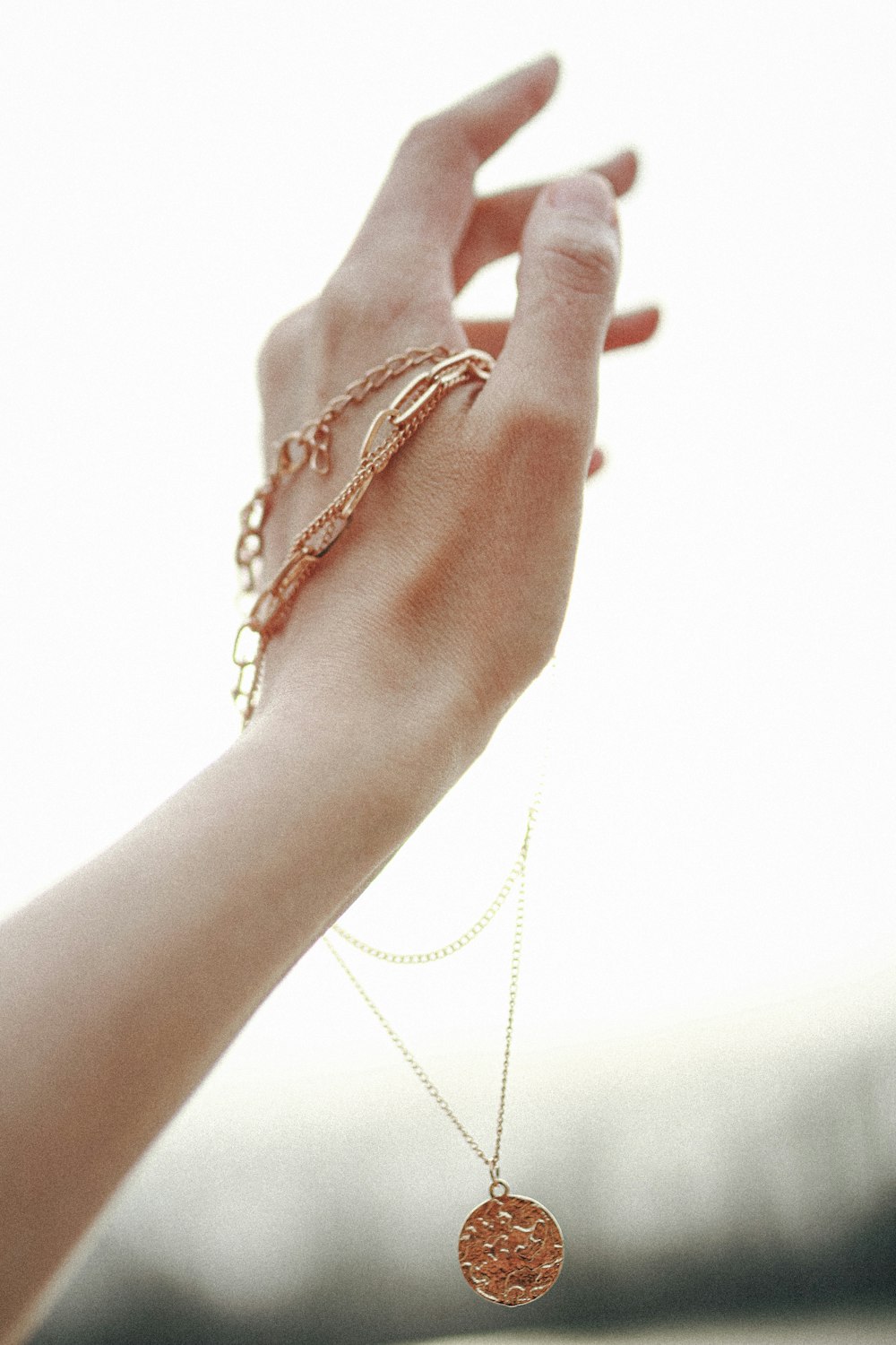 person wearing gold bracelet and bracelet