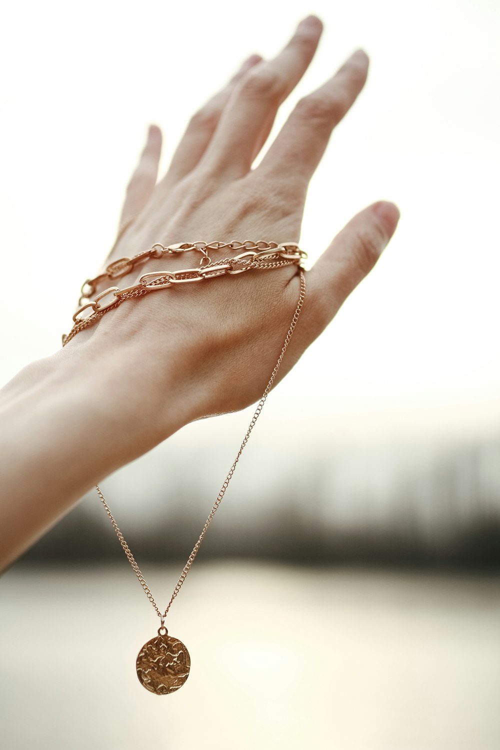 person wearing silver chain bracelet