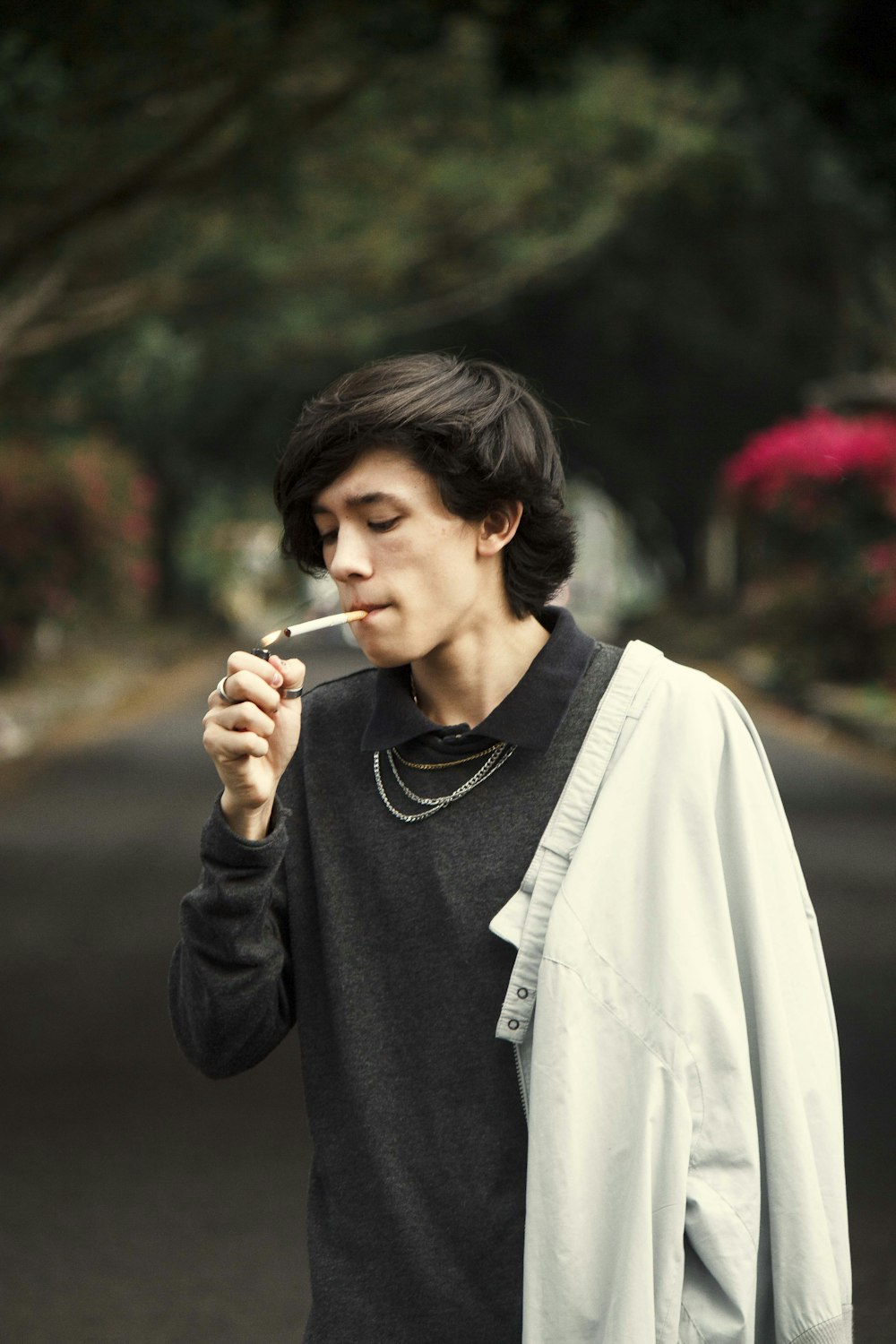 man in black crew neck shirt smoking cigarette