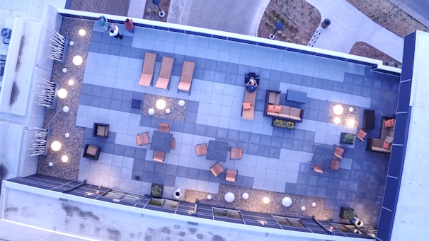 A stylish concrete patio with modern seating and ambient lighting in Aurora.