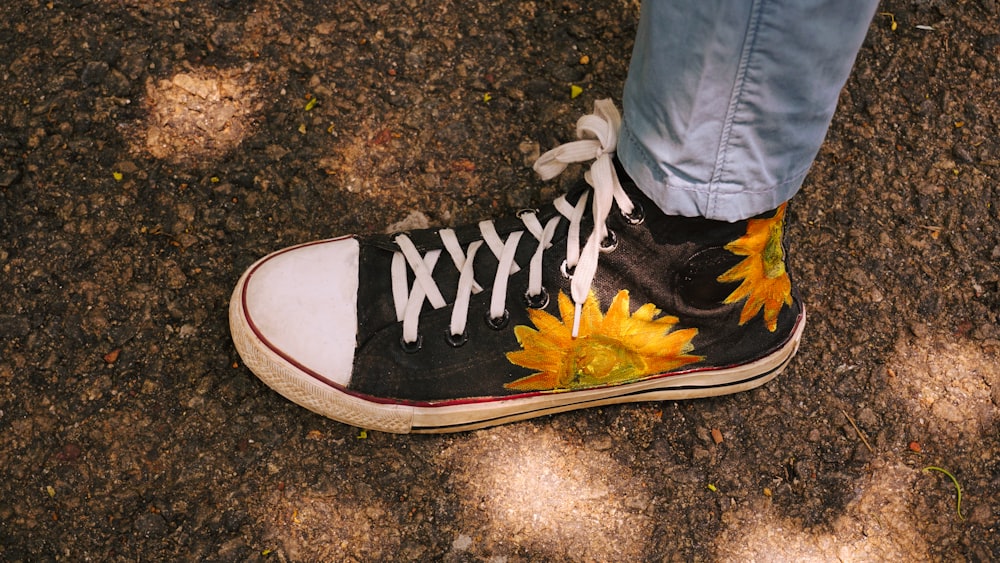 person wearing black and yellow nike sneakers