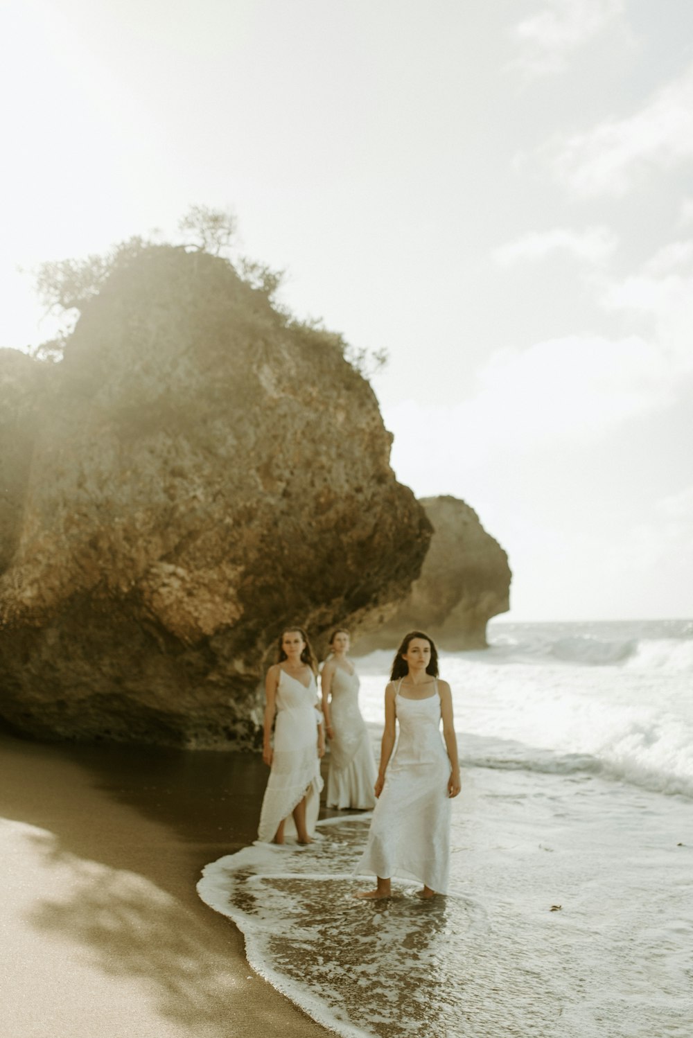 woman in white dress standing on seashore during daytime