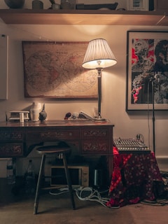 A sleek, dimly lit studio corner showcasing a Lacroix-designed workspace with ambient gold lighting and a vintage analog sound system.