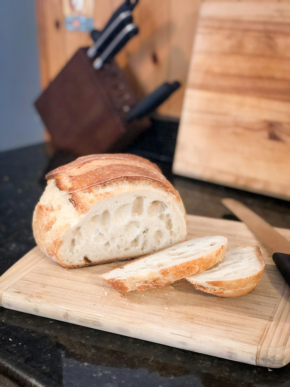 sliced bread on brown wooden chopping board