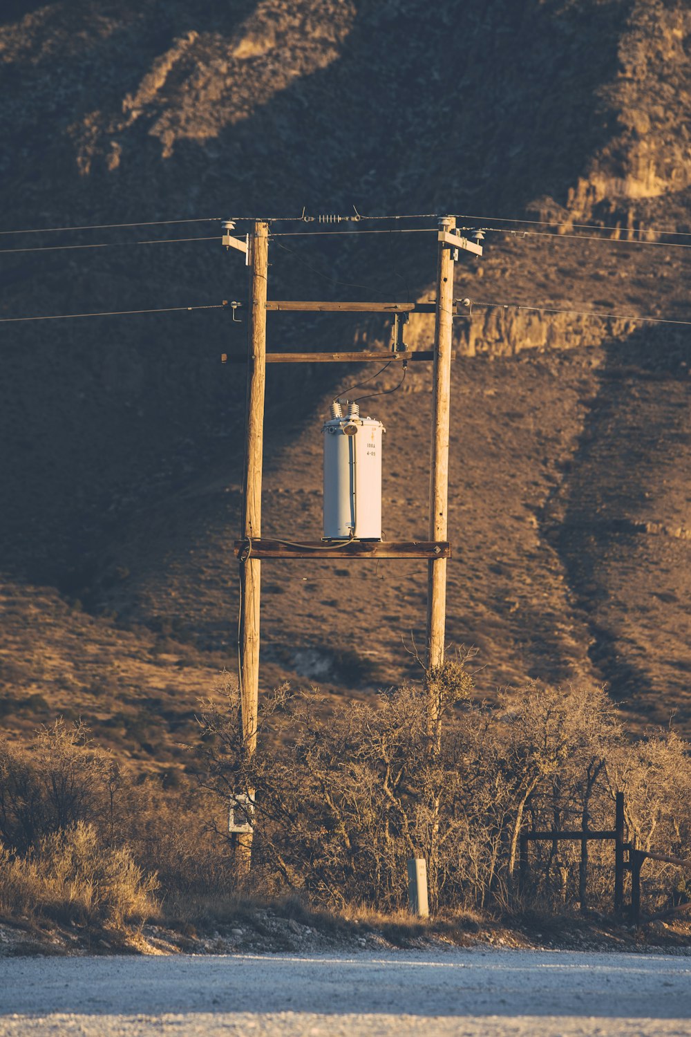 white metal tank on brown wooden post