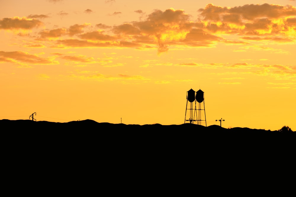 silhouette of people standing on top of mountain during sunset