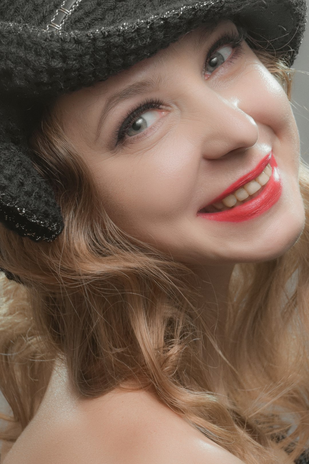 woman in black hat smiling