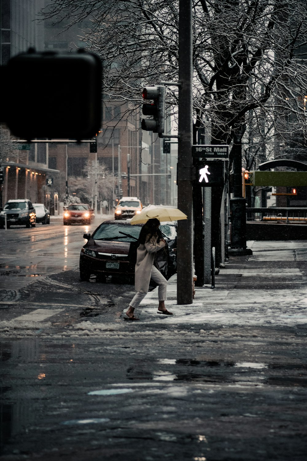 woman in white dress walking on sidewalk during daytime