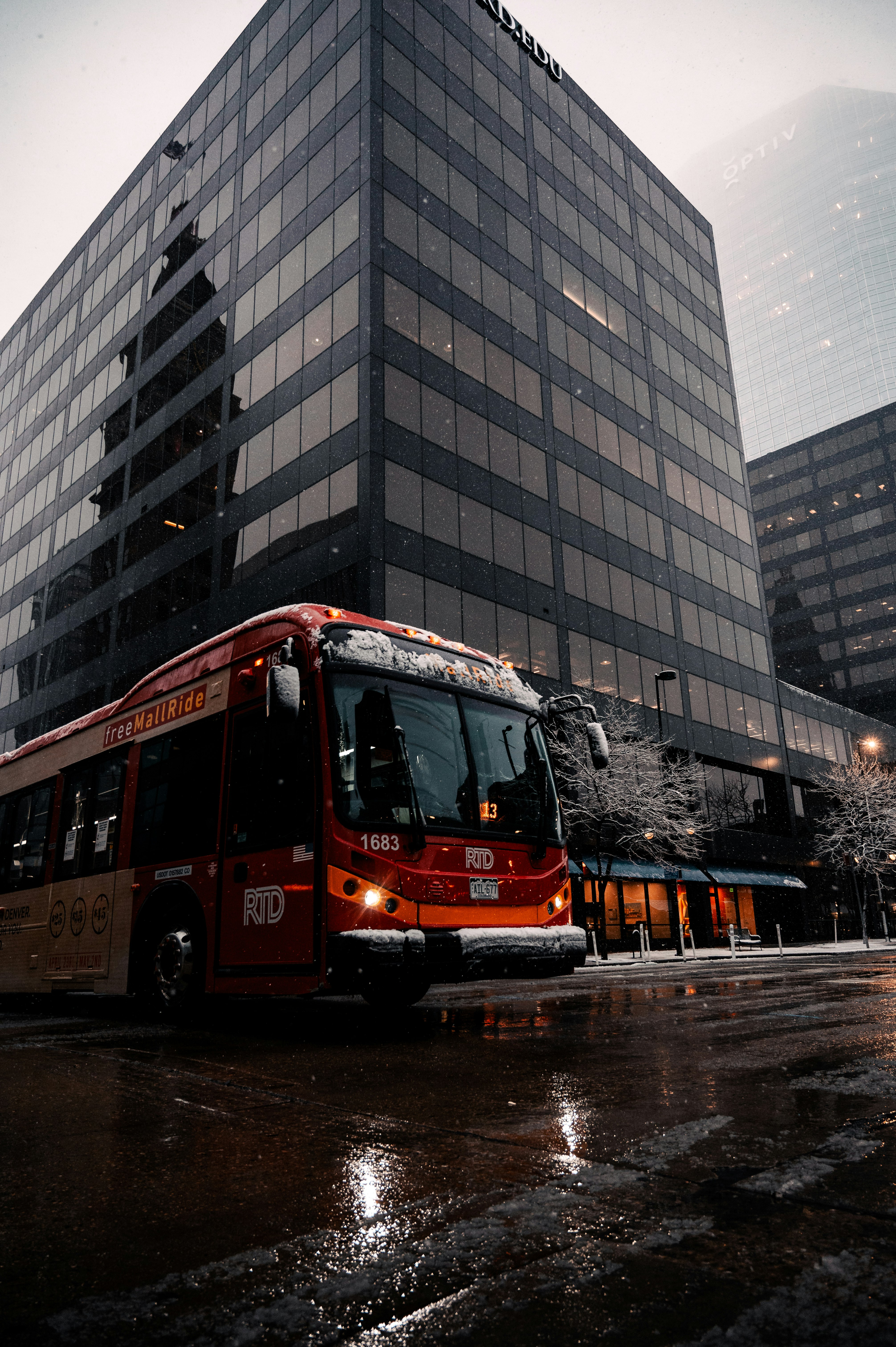 red double decker bus on road near building during daytime