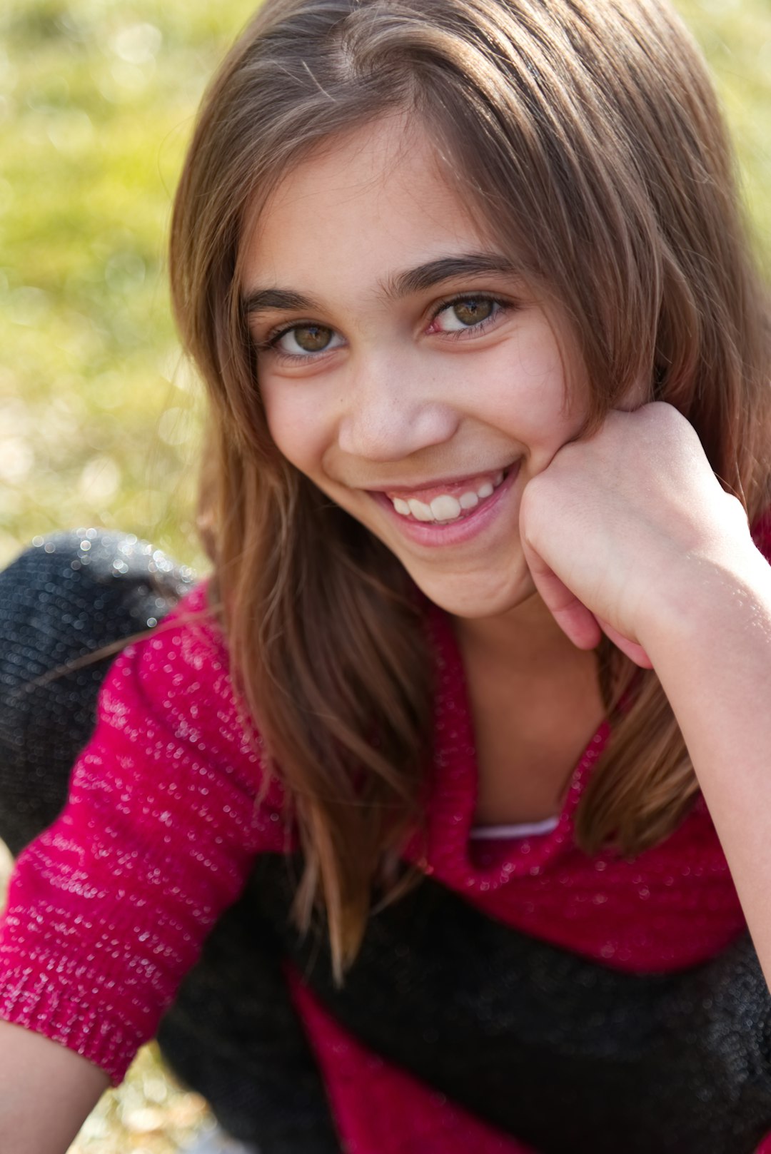 smiling woman in red and black scarf