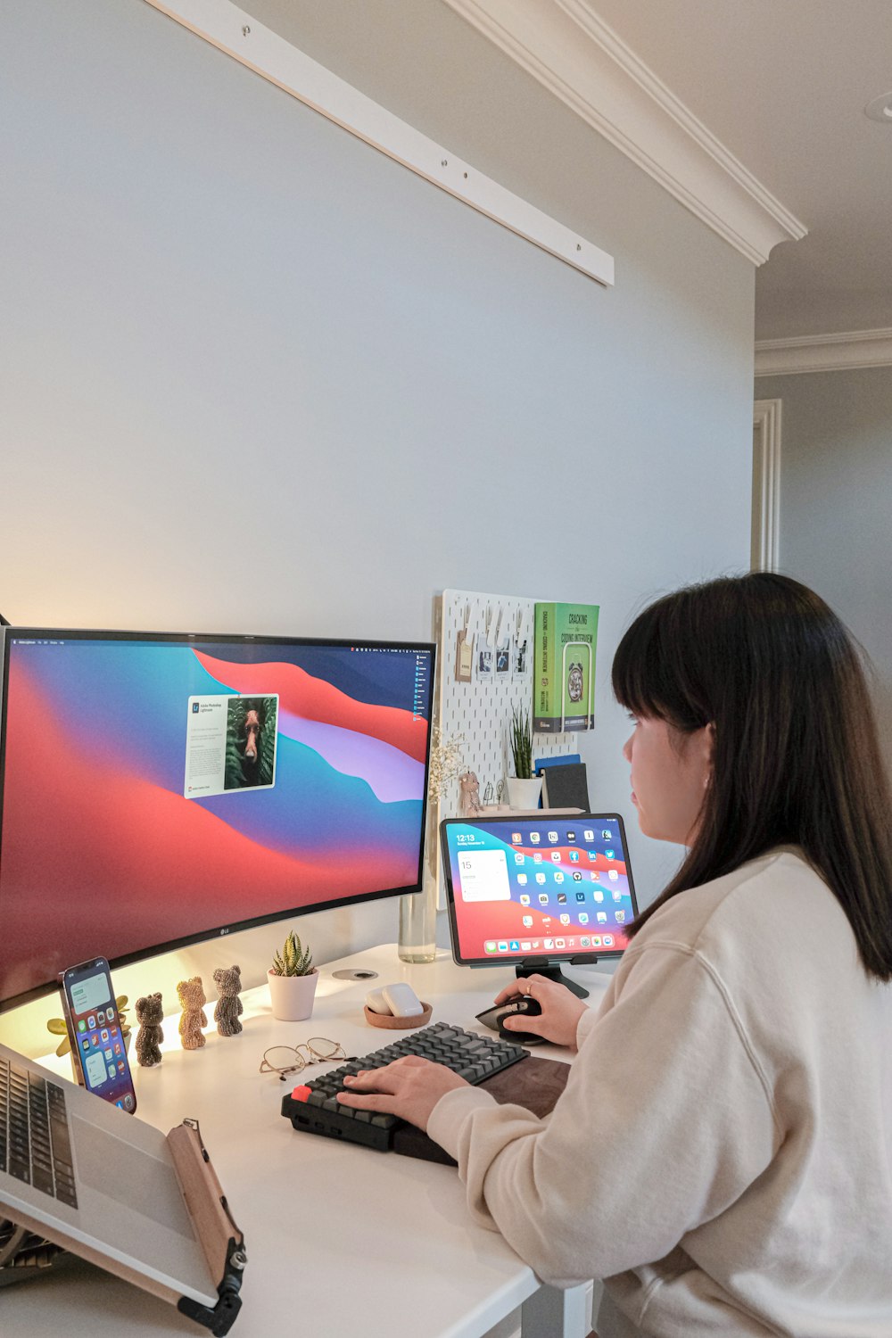 woman in white long sleeve shirt sitting in front of computer