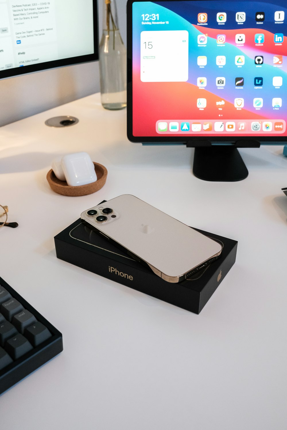 black ipad mini box beside white ceramic mug and black computer keyboard