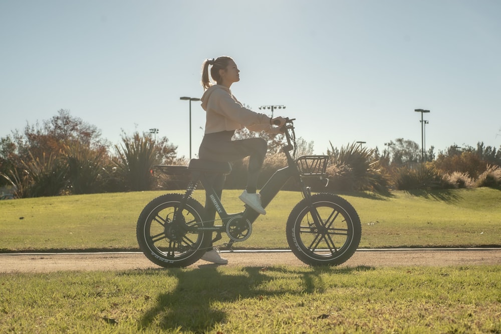 woman in white shirt riding on motorcycle during daytime