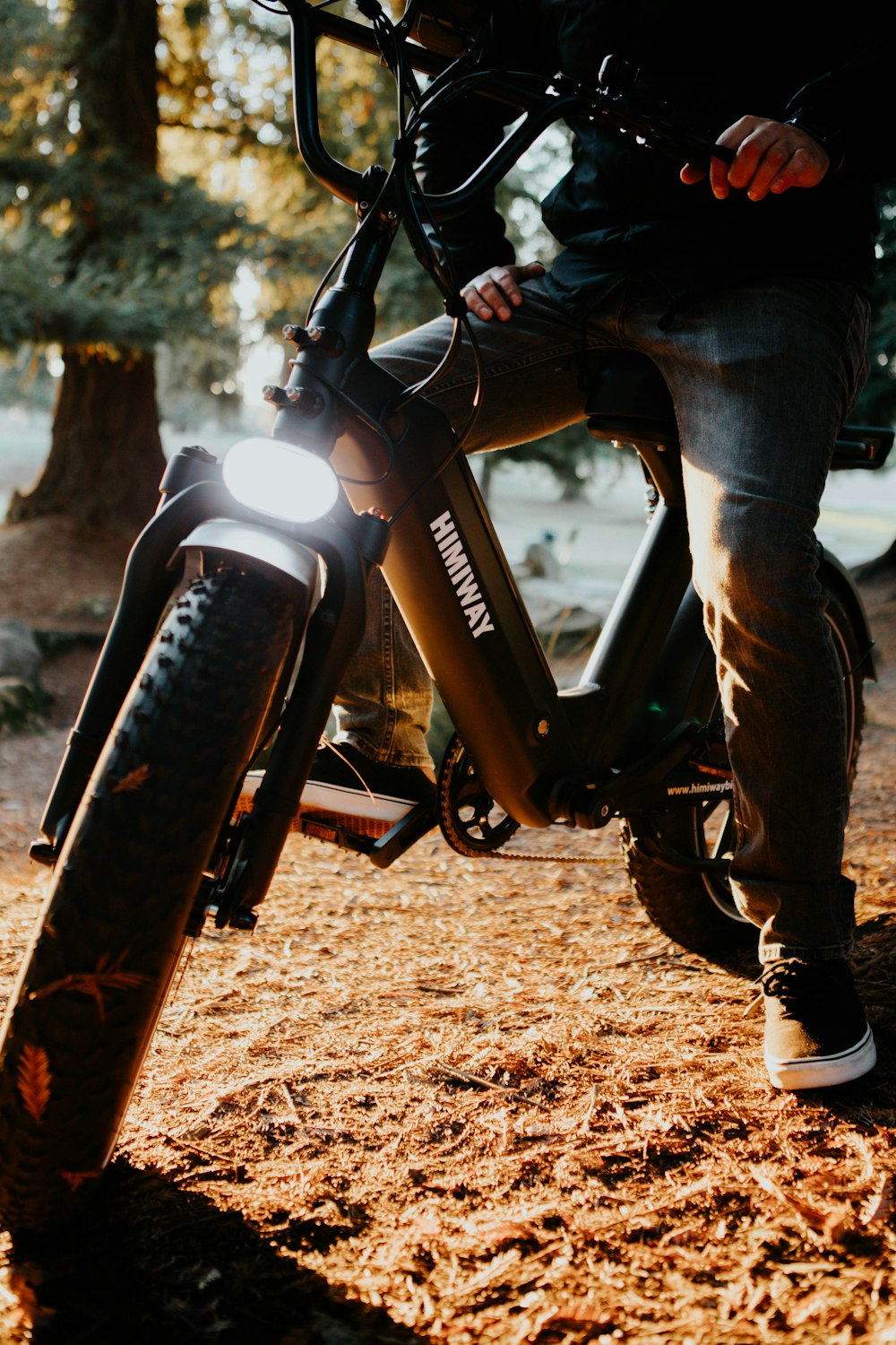 person in blue denim jeans riding on orange and black dirt bike